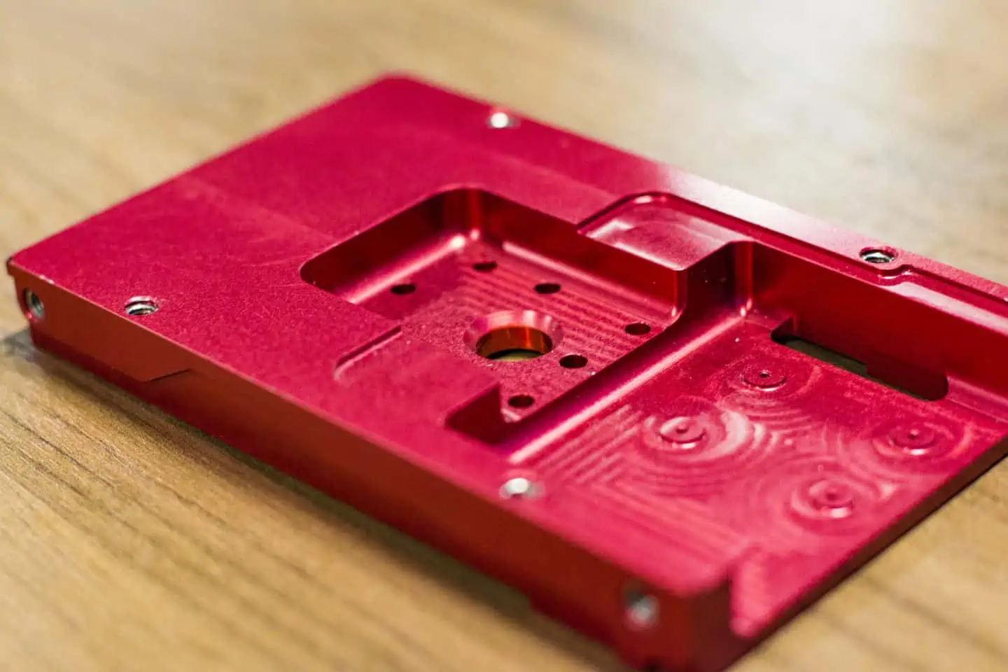 CNC machined part with a red anodised surface finish