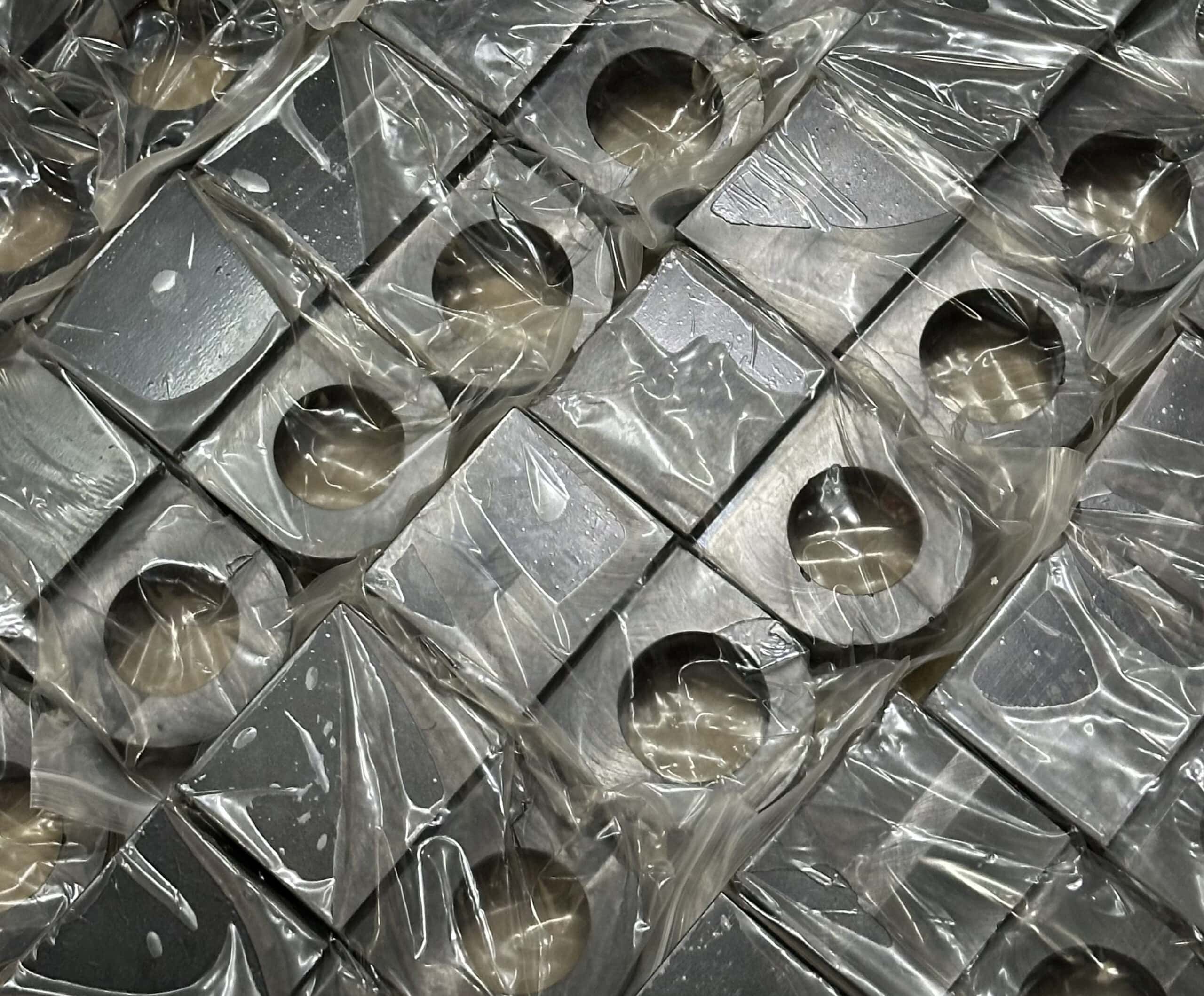 Dozens of individually wrapped CNC machined clevises for hydraulic cylinders
