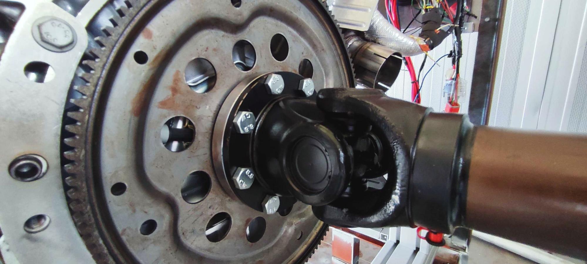 Close-up of the CNC-machined steel cardan adapter mounted on the Ford engine flexplate